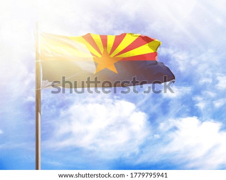 National flag of State of Arizona on a flagpole in front of blue sky