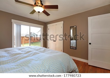 Bedroom with blue bedding and view of the back yard