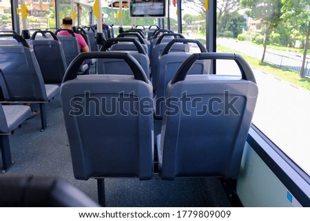 Back view of bus seats on double decker bus. Blank advertising space; for mockup display; bus seat sticker wrap. Empty bus. Royalty-Free Stock Photo #1779809009