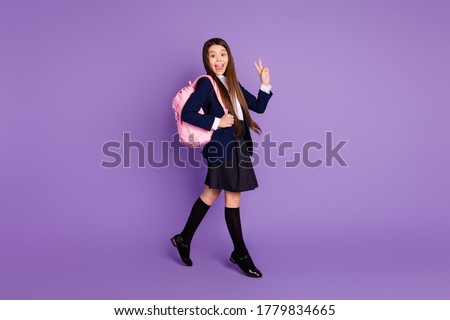 Full length body size profile side view of her she attractive cheerful optimistic schoolchild going back to school showing v-sign isolated violet lilac purple pastel color background