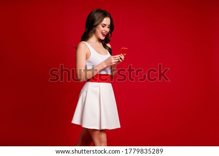 Profile photo of funny nice lady good mood hold telephone hands chatting friends walk street friends meeting wear white short dress isolated red color background