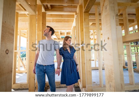 Loving couple at construction site of their new home dreams come true Royalty-Free Stock Photo #1779899177