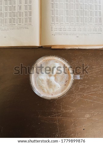 cappuccino and open old book