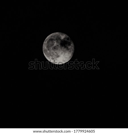 Super Moon in dark night behind the clouds, the moon hide behind clouds during night time