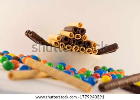 chocolate sticks and multi color chocolate ball on white background with a depth of field view.
