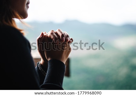 The girl bowed and prayed at sunset in the mountains On a relaxing day To think of a loving God, we praise God. Royalty-Free Stock Photo #1779968090