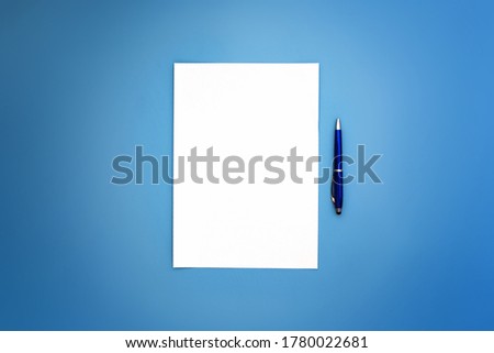 Wide image of A4 white sheet and blue pens