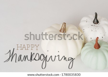 White minimalism pumpkins with happy thanksgiving message for holiday.