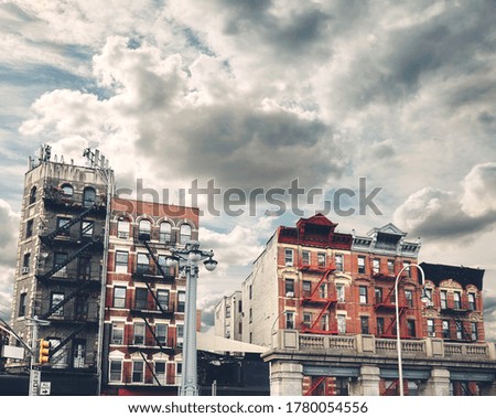 Retro toned picture of old buildings with fire escapes, New York City, USA.