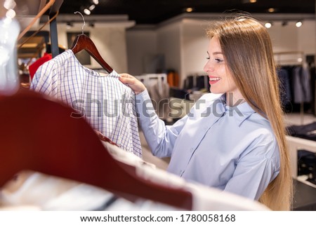 beautiful young holder of a fashion store checks a product in her boutique Royalty-Free Stock Photo #1780058168