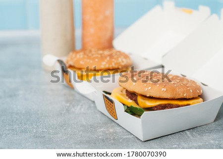Vegan burgers in a paper box with food delivery.Natural juice on the background.