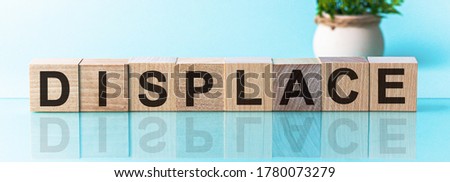 DISPLACE word written on wood block, blu background