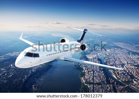Private jet plane in the blue sky Royalty-Free Stock Photo #178012379