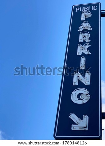 Close-up parking signage with blue sky background