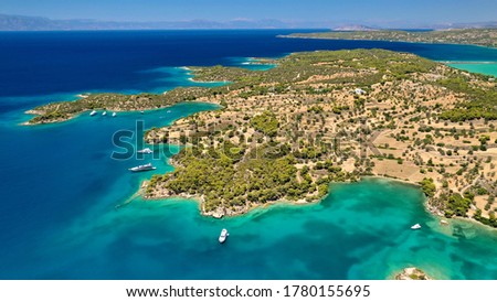 Aerial drone photo of beautiful fjord landscape forming turquoise beaches in small vegetated coves in Porto Heli a popular anchorage for yachts and sail boats, Argolida, Greece