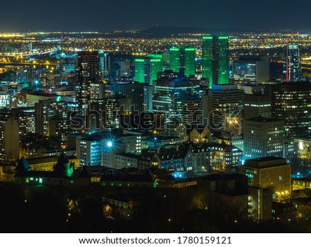 high view of a city at night with tall buildings