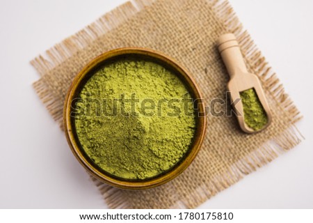 Herbal henna or Mehandi powder in a bowl forming heap, Used for Tattoo or Hair Dye in India