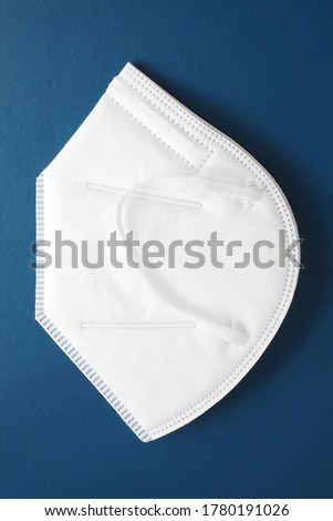 N95 / KN95 face mask on blue background.
 Royalty-Free Stock Photo #1780191026
