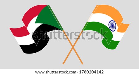 Crossed and waving flags of Sudan and India