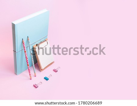 Modern school supplies isometric view. Still life.Pastel colors business supplies. School concept modern poster. Planner book, clipboard, pen, clips, binder. Light pink and mint colors. Space for text