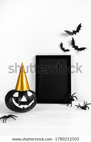 Halloween mock up. Black photo frame and paper art  abandoned village , pumpkin on white background. 