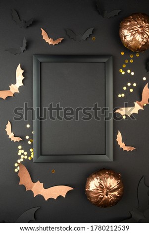 Halloween composition mock up. Black photo frame, flying black paper bats on purple background.  Flat lay, top view, copy space