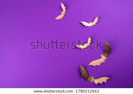 Halloween mock up concept.  Flying black paper bats on purple background