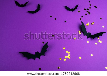 Halloween mock up concept.  Flying black paper bats on a purple background
