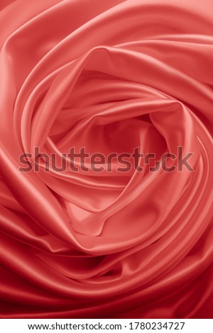 Beautiful elegant wavy red satin silk luxury cloth fabric texture with red background design. Card or banner. Copy space
