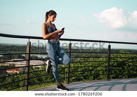 Young athlete women looking at mobile phone