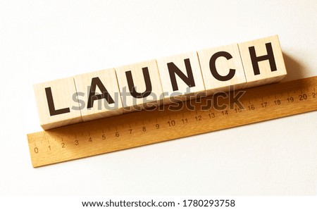 Word LAUNCH made with wood building blocks