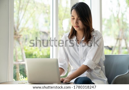 Young woman is working on a laptop in cafe. Lifestyle women in the city concept , work from home