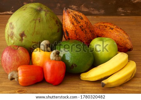 Colorful assortment of fruits, on a wooden table.                             