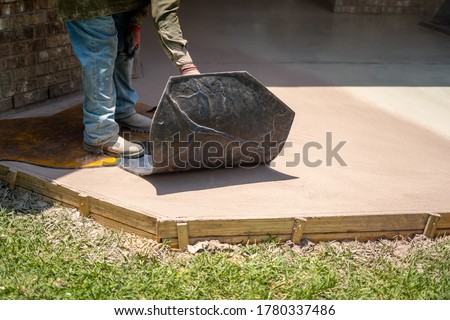 Concrete being stamped with pattern  Royalty-Free Stock Photo #1780337486