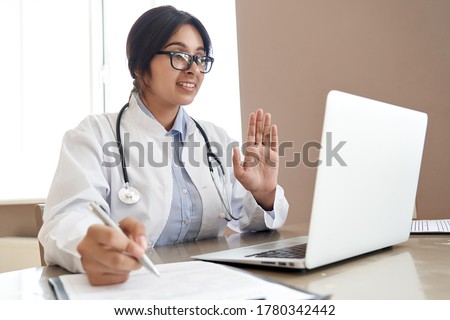 Indian female doctor talk with patient make telemedicine online webcam video call. Female physician therapist videoconferencing on computer in remote telemedicine laptop virtual chat. Telehealth. Royalty-Free Stock Photo #1780342442