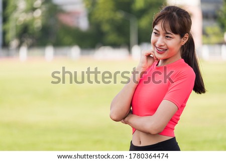 Portrait of a fit and frim young woman wears sport clothes ready to workout in the city stadium in the morning. Healthy and recreation stock photo.