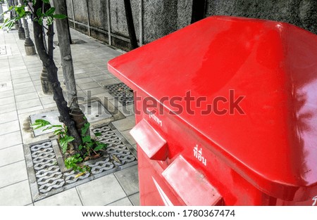 vintage red post box on street.