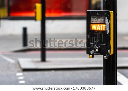 Crosswalk button for pedestrian with light warning on a defocused background , London, UK - image