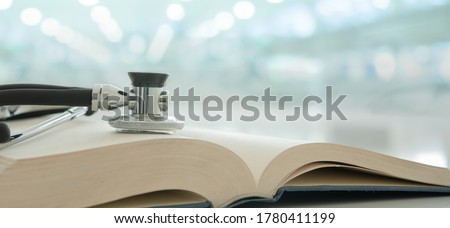 stethoscope on stack of medical guide book for doctor learning treatment at hospital. Royalty-Free Stock Photo #1780411199