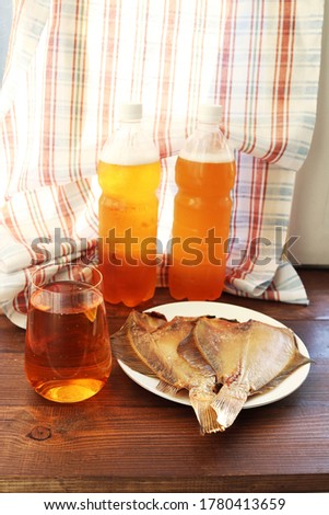 Appetizing and bright still life with draft light beer and smoked flounder. An ideal snack for beer drinks.