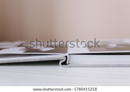Buttom view of open photobook on white wooden table