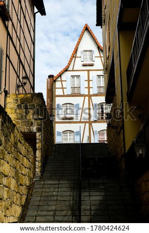 A picture of French Colmar building design from an alley in the morning.