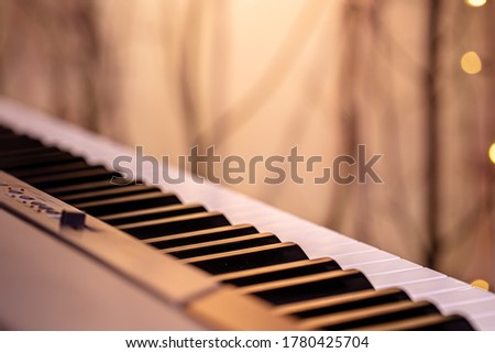 Piano keys on a beautiful colored background. Close up.