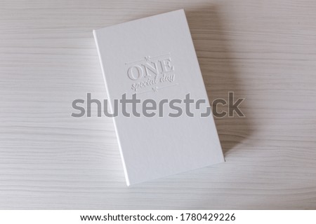White box for printing photo. Box with lettering on white wooden table