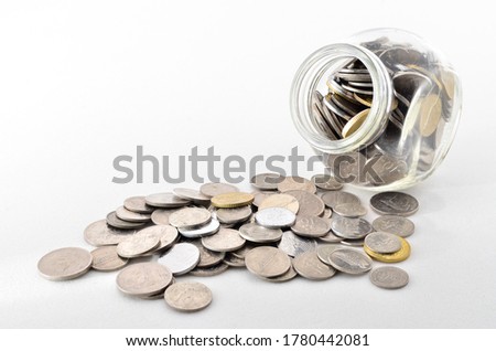 Malaysian Coin in glass container. Shoot over white background. Focus on the important part. Shallow depth of field.