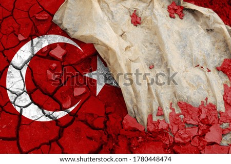 Turkey flag is pictured on cracked ground. The Concept of Ecology with Environmental Pollution from Domestic and Industrial Waste.