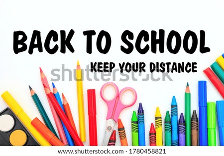 BACK TO SCHOOL KEEP YOUR DISTANCE text message and school supplies on white background, Coronavirus spread in school prevention measure