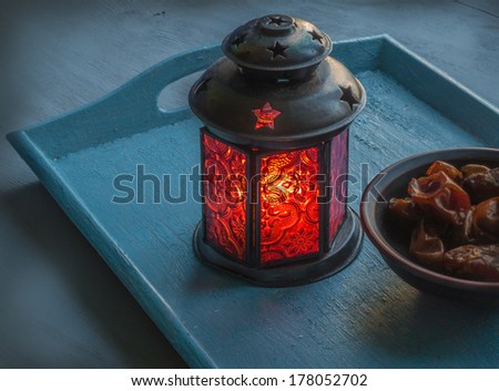 Ramadan lamp and dates on a wooden tray Royalty-Free Stock Photo #178052702