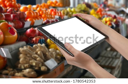 Wholesale trading. Woman using WMS app on tablet at market, closeup  Royalty-Free Stock Photo #1780542353