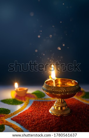 Happy Diwali, Glittering diya oil lamp against dark background with copy space Royalty-Free Stock Photo #1780561637